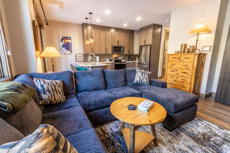 Sink into your spacious sectional sofa and enjoy the open-concept living space that flows seamlessly into your fully equipped kitchen.