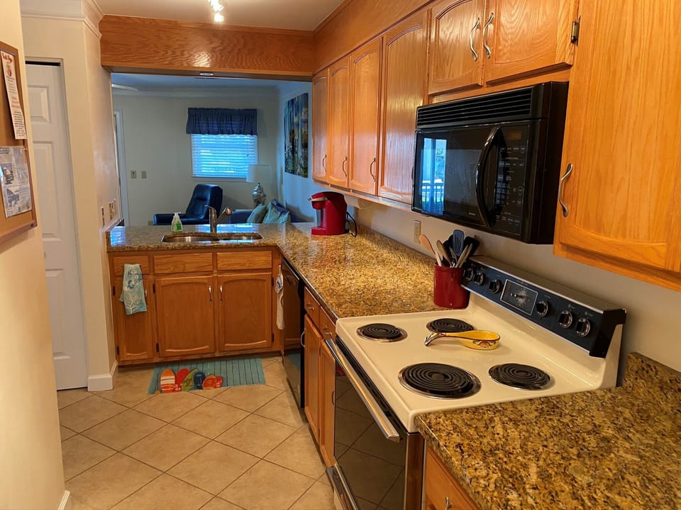 Kitchen with dishwasher,  stove. microwave and refrigerator.   