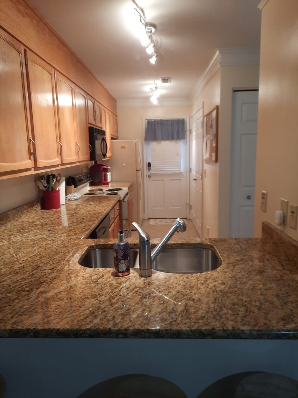 kitchen counter,  with 3 bar stools. 