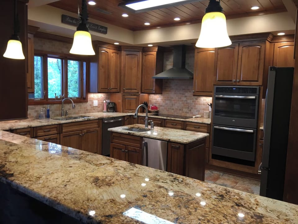 The kitchen has a double oven, an ice machine, a wine cooler, and a large island
