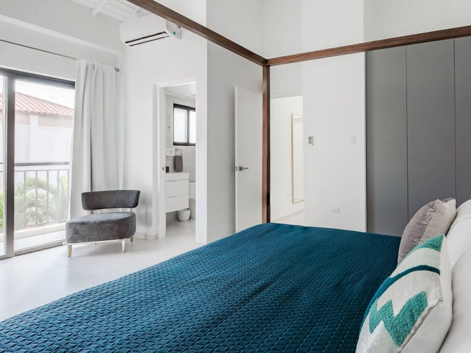 Bedroom 2 (Upstairs): King bed, full ensuite, TV, A/C, fan, balcony