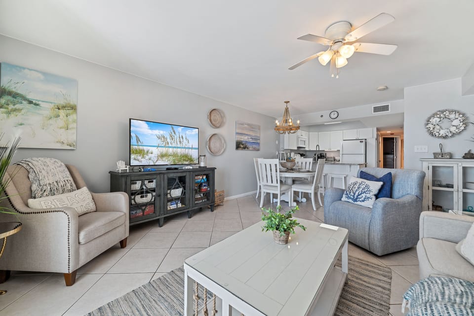 Subtle coastal touches and a neutral palette create a serene and relaxing ambiance in this open living and dining space.