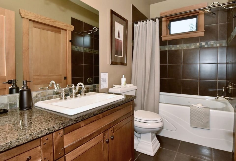 Upstairs bathroom features a jetted tub, a "comfort" toilet & a rainhead shower.