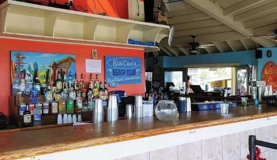 Beach side bar with TVs, music, drinks and grill. 