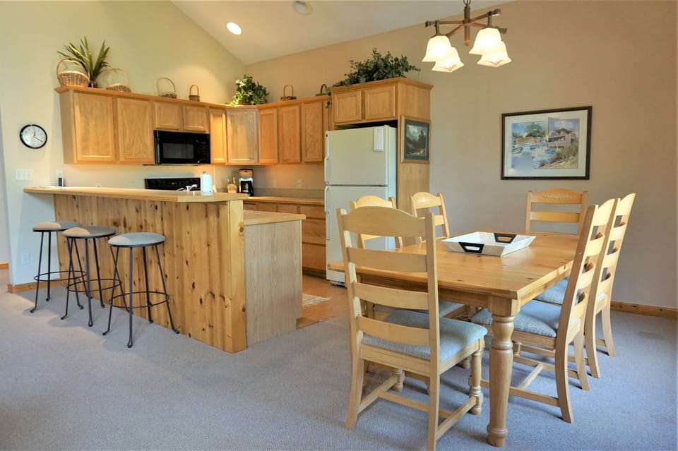 Dining Room/Kitchen - cathedral ceiling, 2 story windows let in natural light.