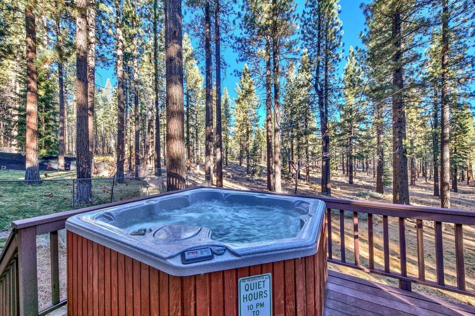 Soak in your private hot tub surrounded by towering pines and blue sky—pure mountain serenity at your fingertips.