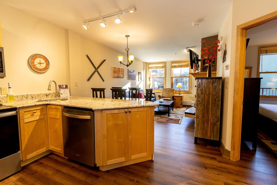 Your spacious kitchen features granite countertops and modern appliances, flowing seamlessly into the cozy living area where you'll love relaxing after mountain adventures.