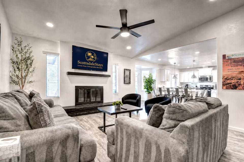 Amazing great room design with wood burning fireplace and big Smart TV.
