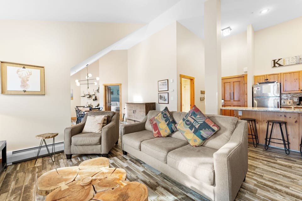 Sink into plush seating where modern mountain style meets comfort, with soaring ceilings and warm wood accents creating your perfect retreat.