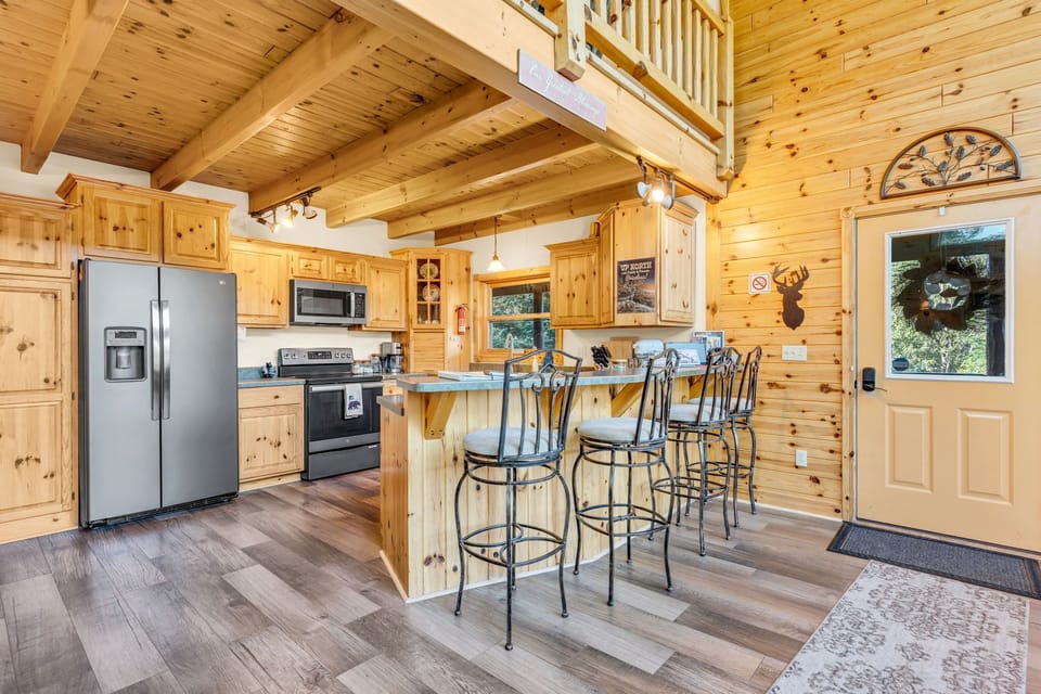 Fully stocked kitchen with newer appliances and seating for 4 at the island.