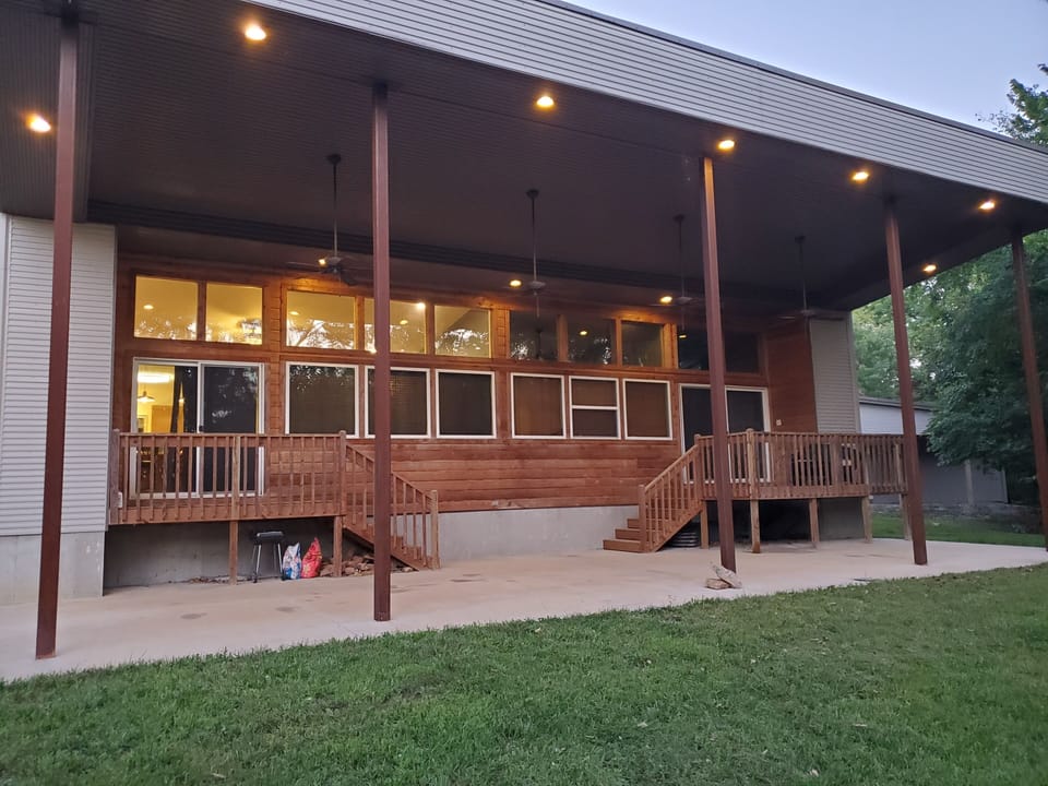 Lake House Exterior facing the lake.  Featuring a 900 Sq ft covered porch.
