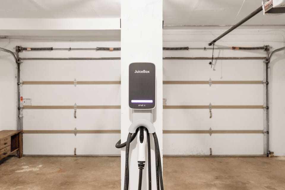 - EV charging station for electric vehicles in garage  
- Modern Juice Box charger for guest convenience  
- Eco-friendly amenity for travelers driving electric
