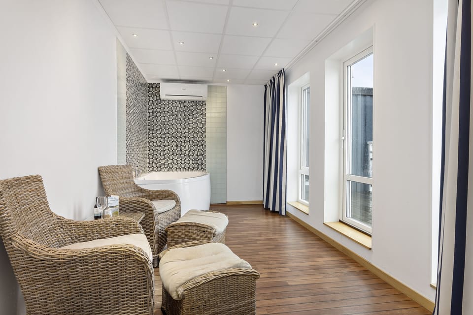 Suite, 1 Queen Bed, Balcony, Sea View | Living area | 32-inch LCD TV with cable channels, TV, streaming services