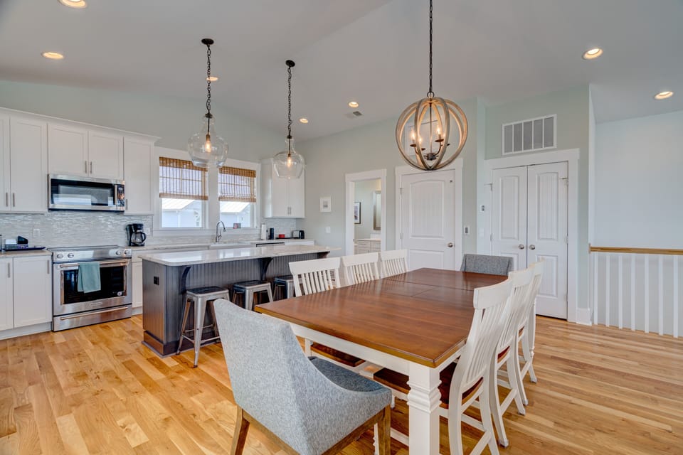Dining room with 8 person dining table and seating for 4 at breakfast bar