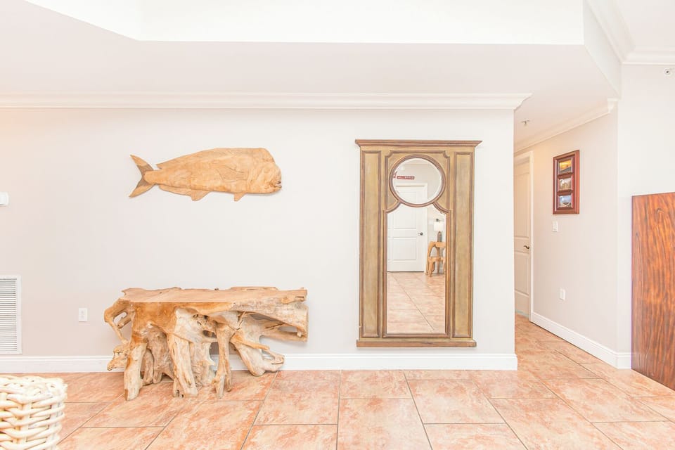 Step inside to discover coastal charm with driftwood art and warm tile floors that welcome you home after your beach adventures.