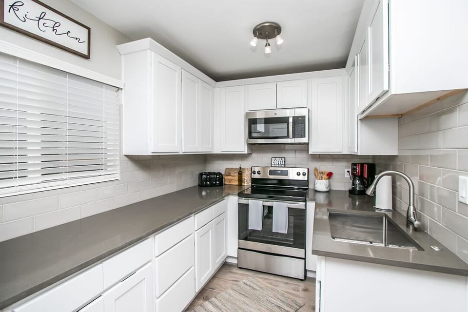 Kitchen with fully equipped with utensils, pots and pans