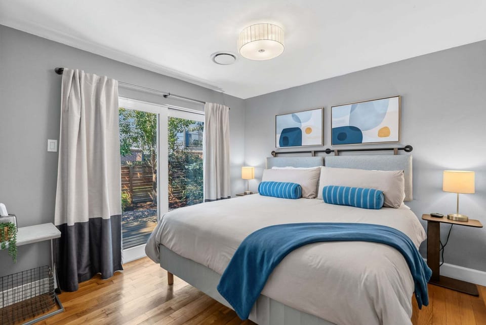 King Suite with Garden Access — A serene primary retreat featuring a plush king bed and private walk-out access to the deck and fenced backyard. 🌿🛏️