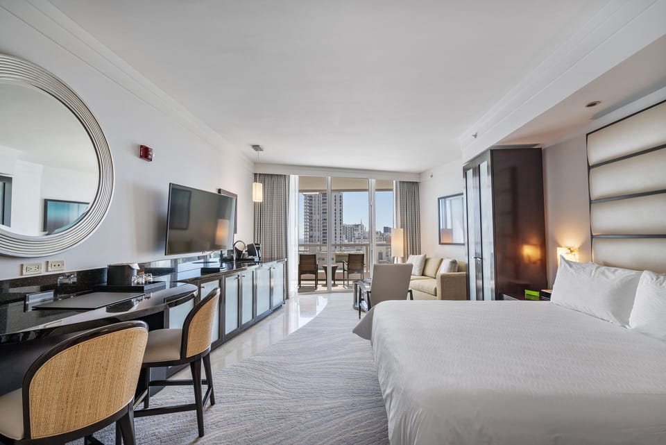 Spacious room with modern furniture in neutral tones.