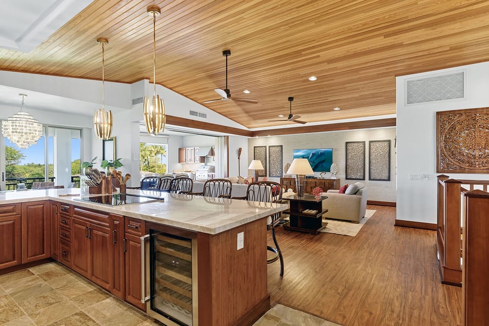 Open concept kitchen and living area that opens up to outdoor lanai
