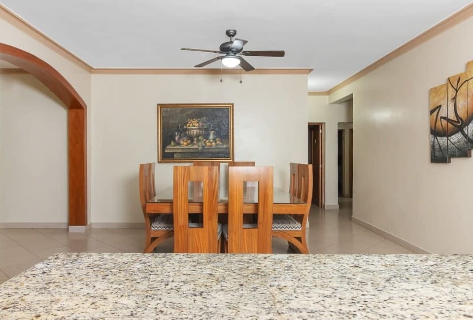 Dining Room: Gather around the elegant table under a stylish fan and enjoy delightful meals together!