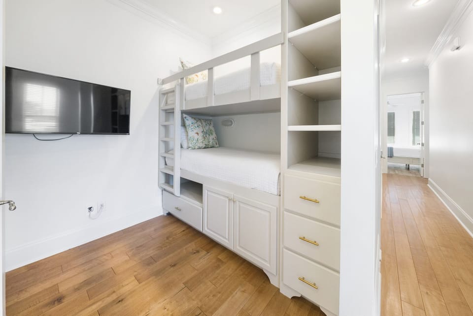 Sleep soundly in your custom bunk bed with built-in storage and entertainment—your perfect retreat with warm hardwood floors and private ensuite.