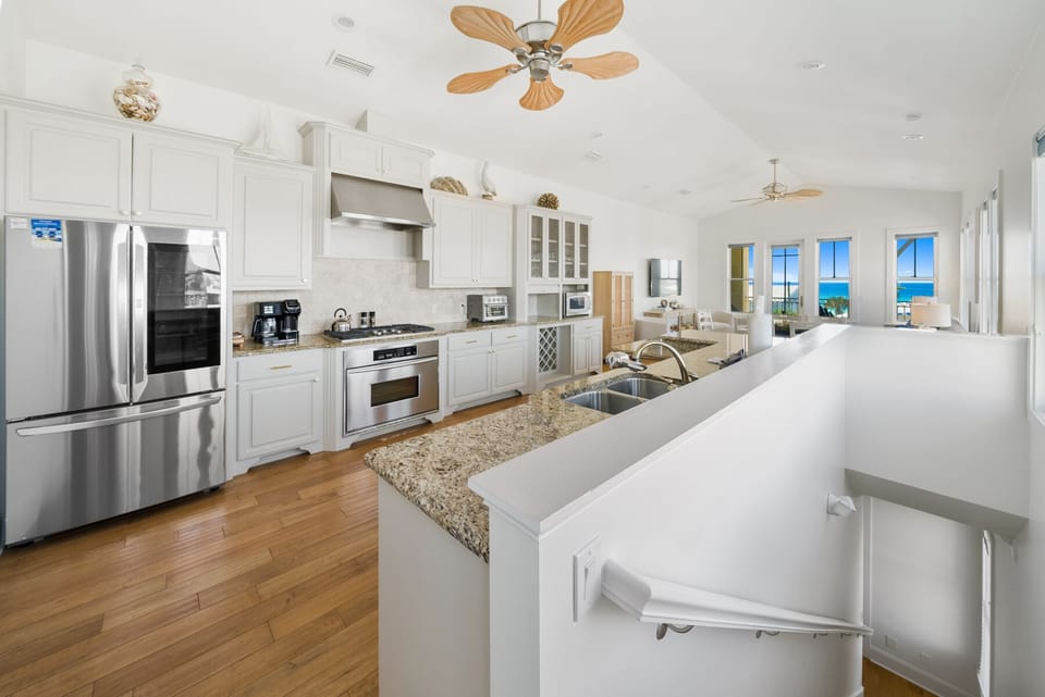 Cook with ease in this stunning kitchen featuring granite countertops, stainless steel appliances, and breathtaking ocean views through every window.