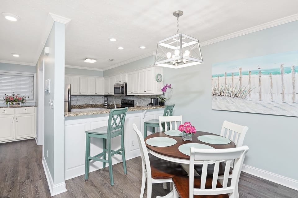 You'll love cooking in this bright kitchen with modern appliances and enjoying meals at your coastal dining table.