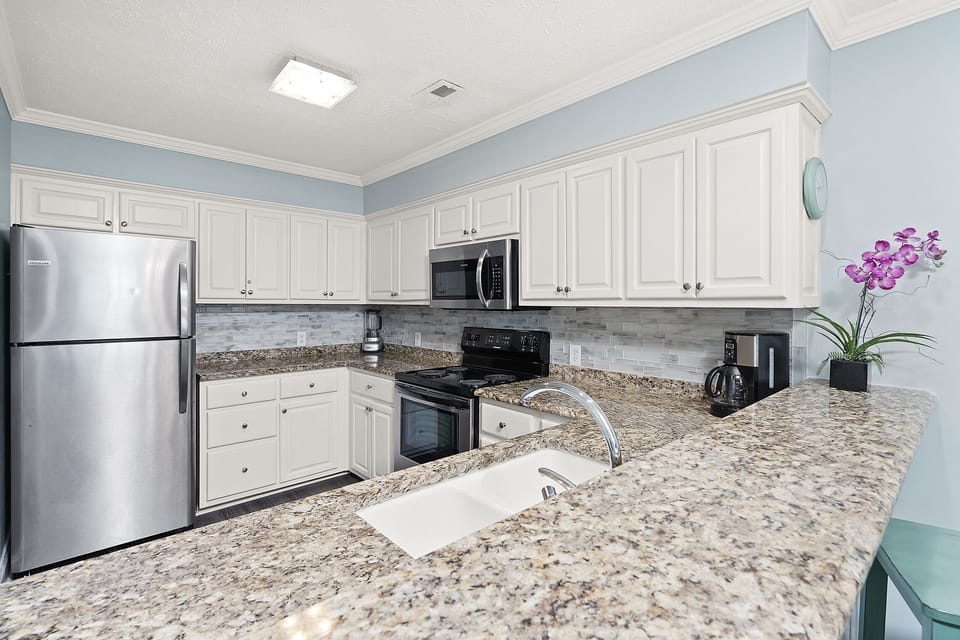 Your fully equipped kitchen features granite countertops, stainless steel appliances, and everything needed to create memorable meals during your stay.