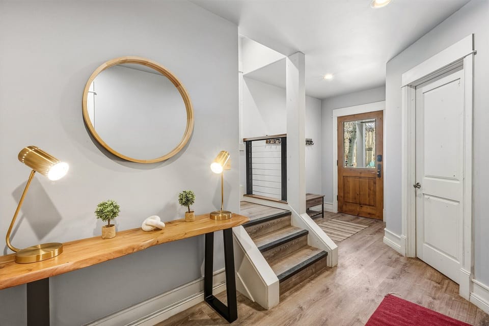 The first floor features three guest bedrooms, one with an en suite bathroom, and an additional shared bathroom in the hallway.