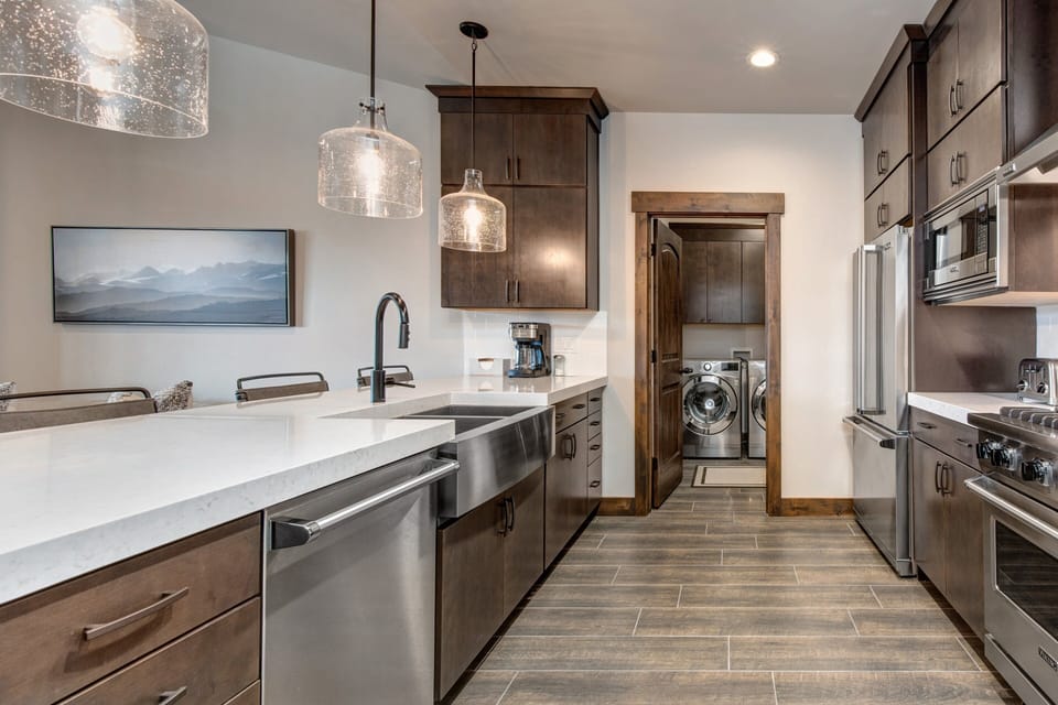 Fully Equipped Kitchen with bar seating for four, stone countertops, and stainless steel Viking appliances