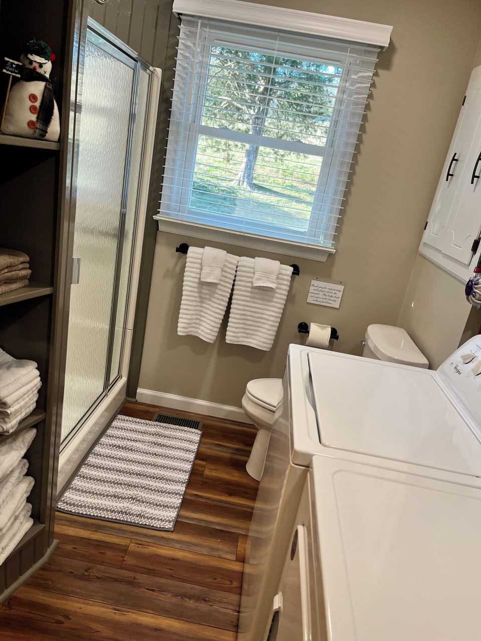 Full size hallway bath with shower. Full size washer and dryer in hallway bath.