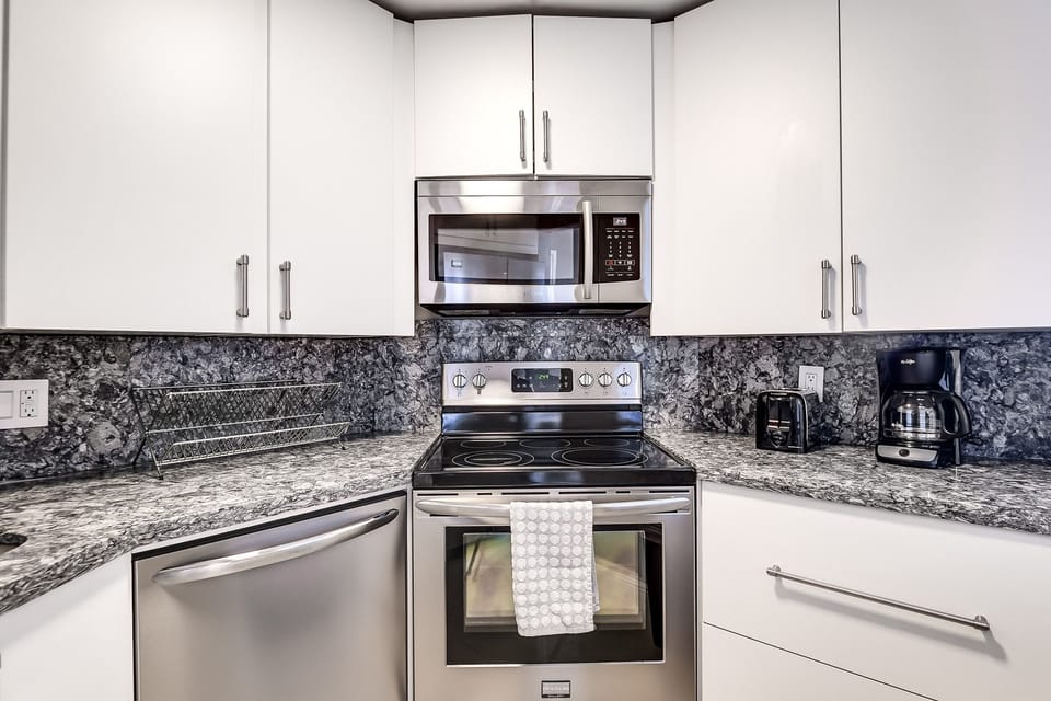 Newly renovated full kitchen with oven, stove, microwave, full size fridge 