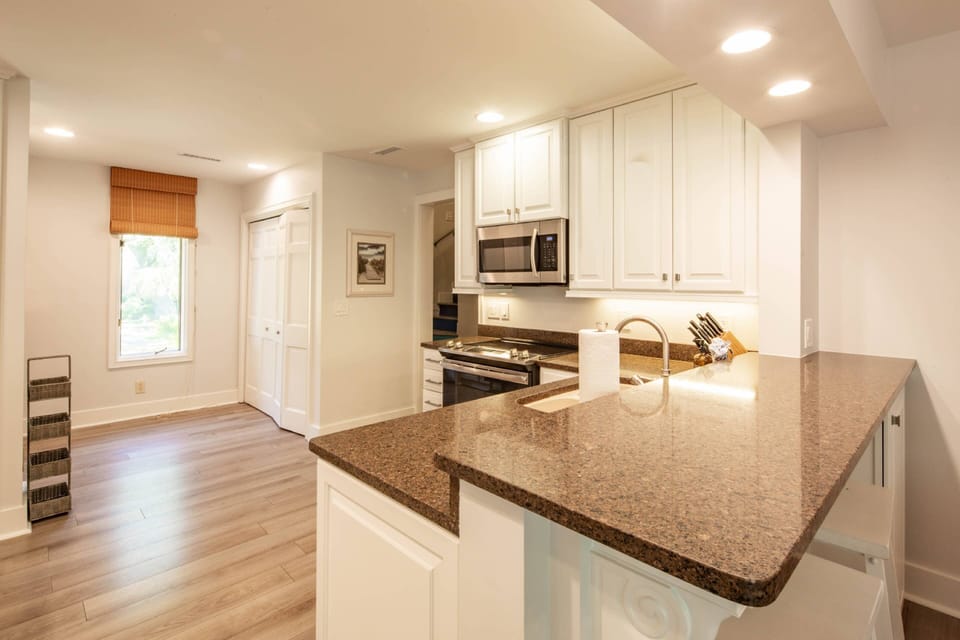 The kitchen features an electric range, microwave and dishwasher.