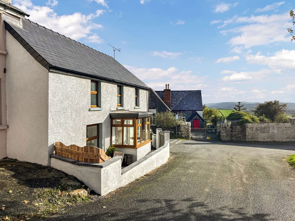 Cottage exterior with the Preseli hills in the distance | Corner House, Mathry