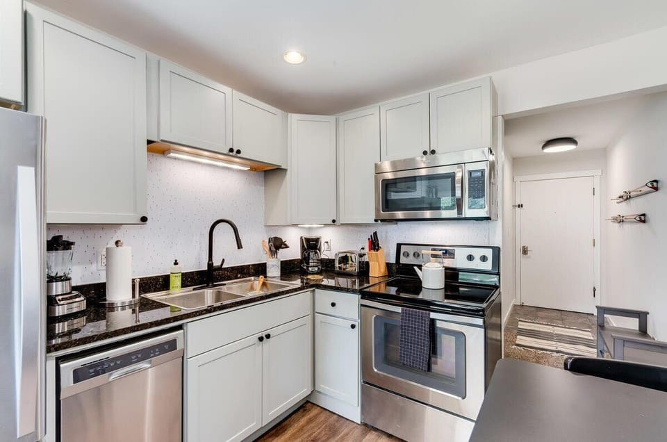 Entry and kitchen stocked with appliances and utensils you need to cook a meal plus coffee.  View from sitting room.
