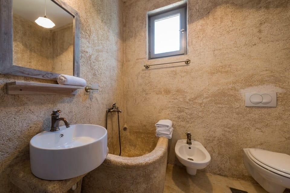 En suite bathroom with shower in Brač luxury beachfront villa Oasis with pool and parking.