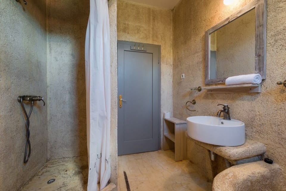 En suite bathroom with shower in Brač luxury beachfront villa with pool and parking.