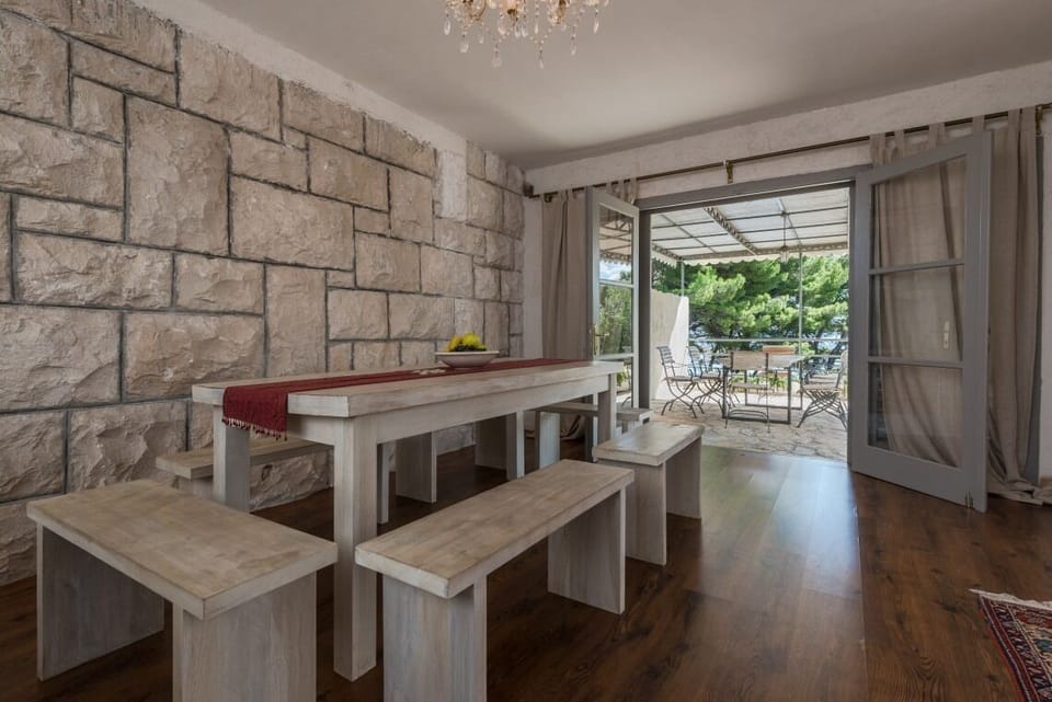 Dining area decorated in Mediterranean style in Bol luxury seafront villa Oasis with parking and pool.