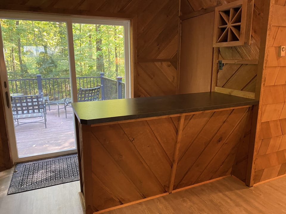 Custom wet-bar & cedar woodwork; the full-sized laundry is behind the door