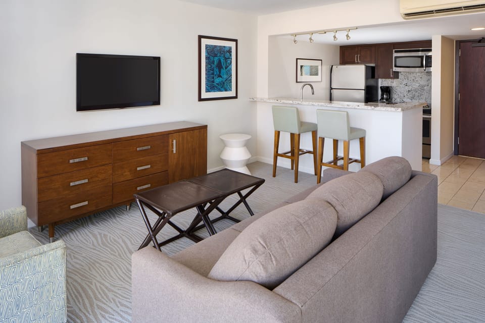 Relax in your bright, open-plan living space with comfy seating, a modern kitchen, and all the amenities you need for a seamless stay.