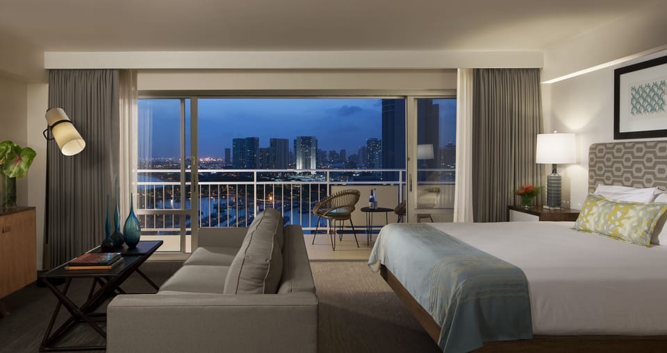 Sink into plush bedding and let the glowing city lights and twilight skies become your evening backdrop. Your private balcony invites you to unwind with the skyline at your fingertips.