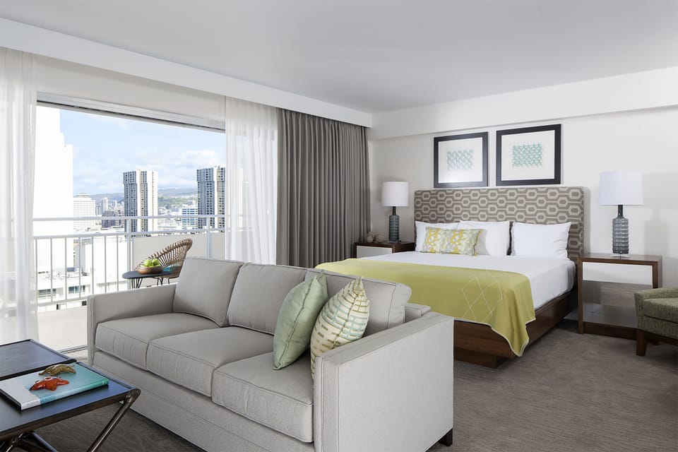 Your bright, spacious retreat combines comfort and style with a plush king bed, cozy sitting area, and stunning city views from your private balcony.