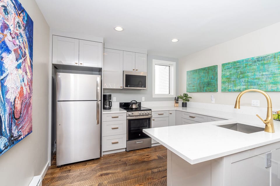 New stainless steel appliances and hard wood flooring.