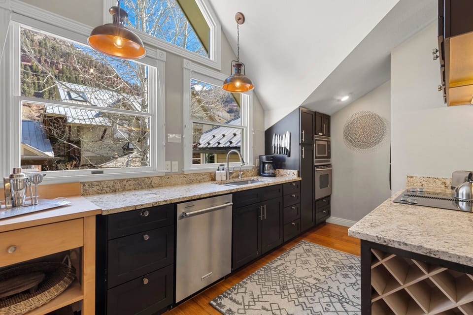 Modern kitchen with stainless steel appliances and granite counters, fully stocked for home-cooked meals.