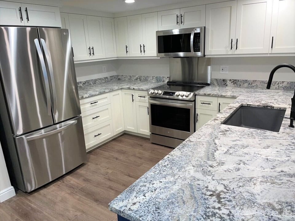 Kitchen: Modern elegance with stainless  appliances & striking granite counters!
