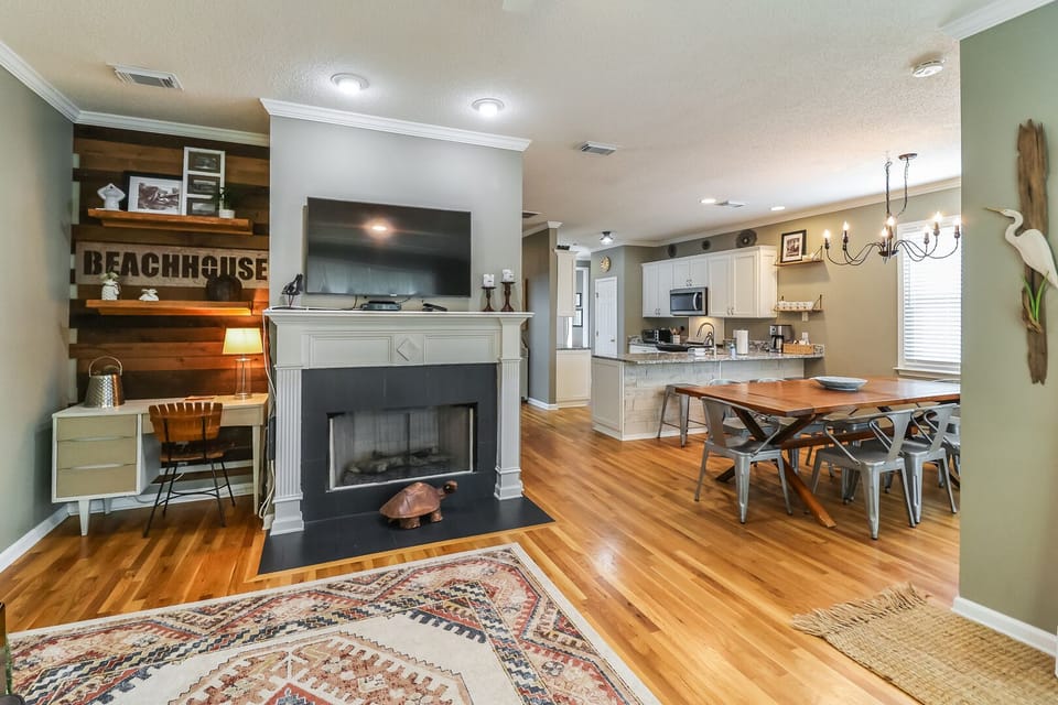 Open floor plan showing dining area, kitchen, and a working corner