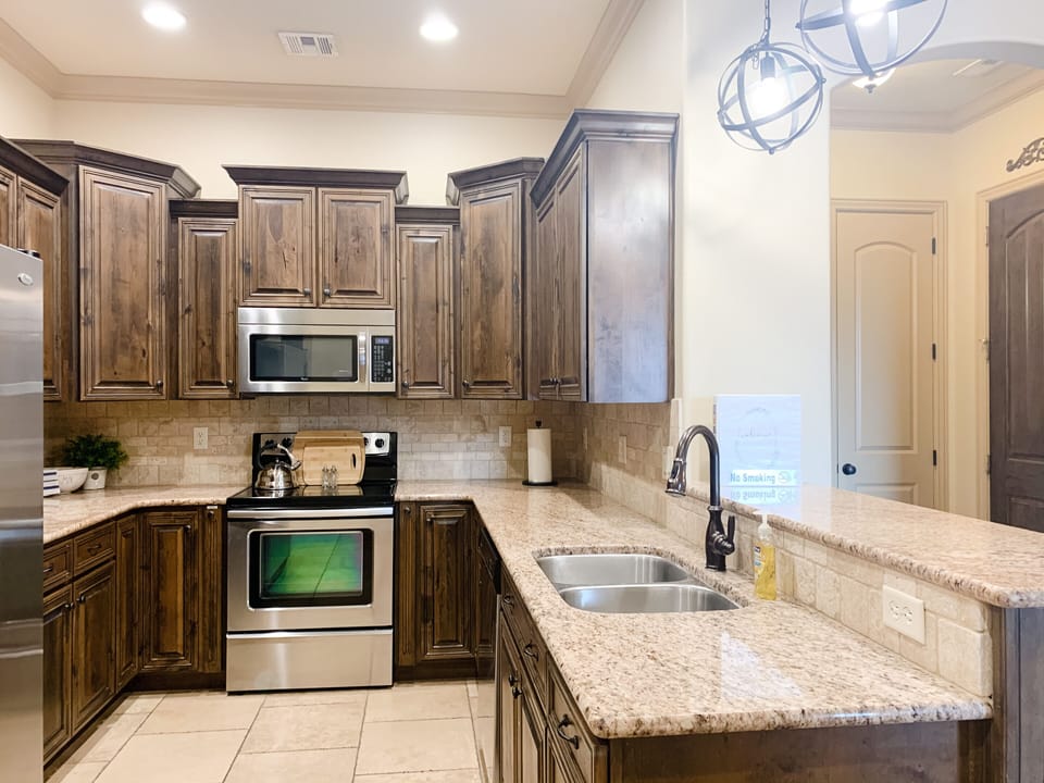 Fully stocked kitchen with table settings for 12
