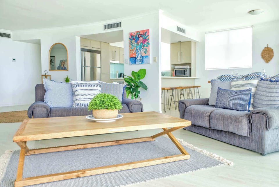 Living area has comfy seating and a large coffee table.
