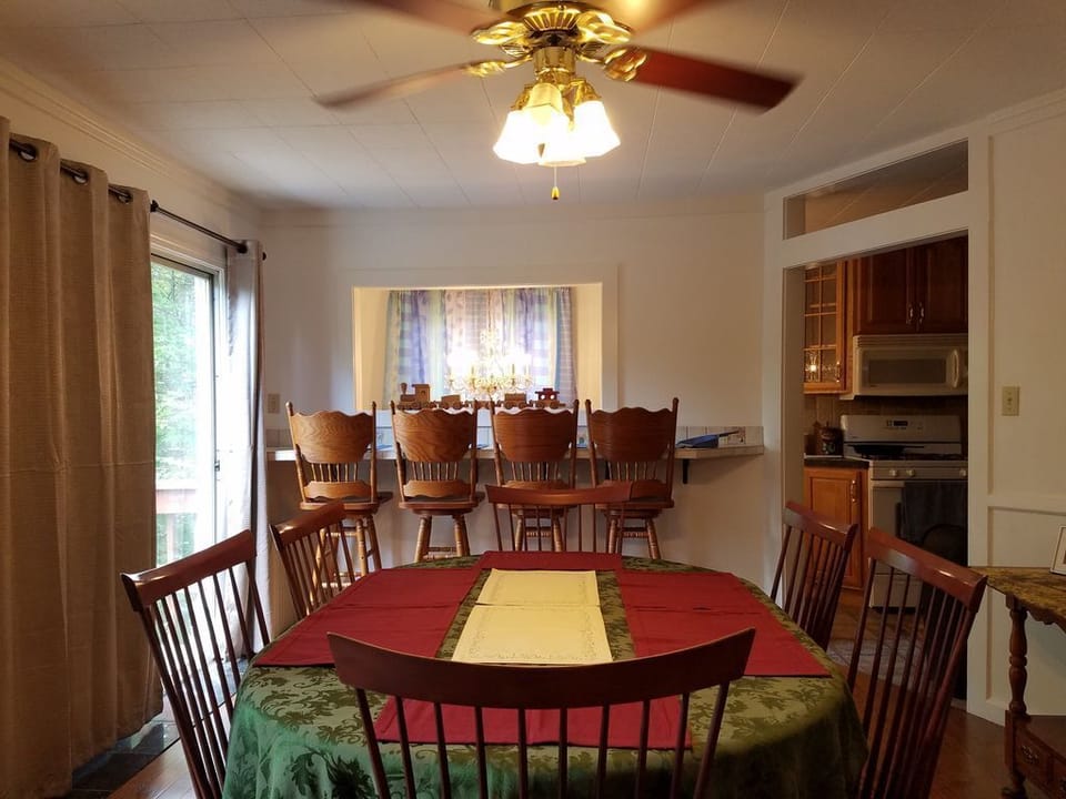 Dinning room, seating for 12. dinning table, love seat and gas fire place decor.