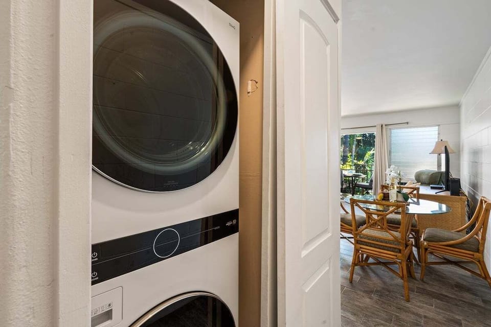 Convenient laundry nook with stacked washer and dryer tucked neatly beside the main living area.